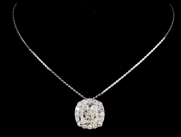 Picture of A Diamond Pendant , featuring a Cushion center stone surrounded by a halo of diamonds