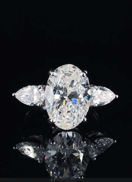 Picture of 5 Carat Oval Diamond Takes Center Stage in Ring,Flanked By Two sparkling pear-Shaped Side Stone