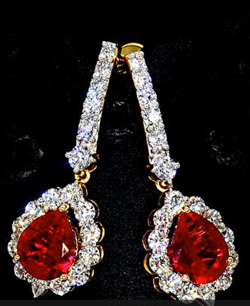 Picture of 4.15 Carat Pear shaped red sapphire earrings surrounded by small diamonds.