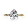 Picture of Pear Shaped Diamond Ring Adorned with Smaller Diamonds.